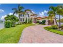 Beautiful home with lush landscaping, a circular driveway, and a well-maintained lawn at 362 41St Ave, St Pete Beach, FL 33706