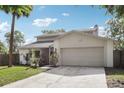Beautifully maintained home with a two-car garage, well-kept lawn, and mature trees at 3802 Cloverhill Ct, Brandon, FL 33511