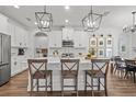 Bright, white kitchen featuring an island with bar seating and pendant lighting at 4777 Ballantrae Blvd, Land O Lakes, FL 34638