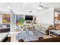 Comfortable living room with tile floors, ceiling fan, sliding doors and exterior view at 615 10Th Ne Ave # 1, St Petersburg, FL 33701