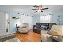 Inviting living room with hardwood floors, comfortable seating, and a decorative fish wall hanging at 753 Almeda N St, St Petersburg, FL 33702