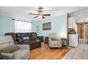 Bright living room with hardwood floors, ceiling fan, and comfortable seating arrangement at 753 Almeda N St, St Petersburg, FL 33702