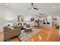 Inviting living room featuring hardwood floors, ceiling fan, neutral paint, and an open concept design at 8078 Pine Crest St, Seminole, FL 33777