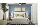 Inviting bedroom with blue walls, a cozy bed, and stylish decor, offering a relaxing retreat at 8086 Painted Sky Pl, Land O Lakes, FL 34637
