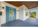 This home boasts a charming covered front porch, a striking blue double door, and modern lighting at 1030 11Th S Ave, St Petersburg, FL 33705