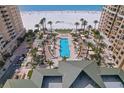 Aerial view of the community pool surrounded by beautiful landscaping and lounge seating at 11 Baymont St # 1109, Clearwater Beach, FL 33767