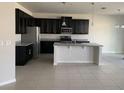 Modern kitchen with stainless steel appliances, granite countertops, and a center island at 11624 Fringetree Ct, Riverview, FL 33579