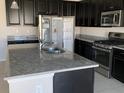 Island sink and stainless steel appliances add to the appeal of this kitchen at 11624 Fringetree Ct, Riverview, FL 33579