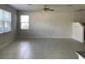 Open-concept living room with tile flooring and plenty of natural light at 11624 Fringetree Ct, Riverview, FL 33579