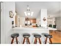 Kitchen and dining area featuring barstool seating and modern appliances at 12501 Ulmerton Rd # 133, Largo, FL 33774