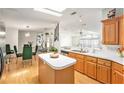Open-concept kitchen featuring an island, stainless steel appliances, and wood flooring at 12501 Ulmerton Rd # 133, Largo, FL 33774