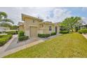 Attractive home featuring a lush green lawn and manicured shrubbery adding to its curb appeal at 1916 Inverness Greens Dr, Sun City Center, FL 33573