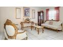 Cozy living room showcasing ornate decor, decorative mirrors, and a vintage grandfather clock at 2182 Corinne S Ct # C, St Petersburg, FL 33712