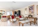 Bright living room featuring tile flooring, ornate furniture, and ample natural light at 2182 Corinne S Ct # C, St Petersburg, FL 33712