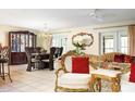 Elegant living room flowing into the dining area, featuring tile floors and ornate decor at 2182 Corinne S Ct # C, St Petersburg, FL 33712