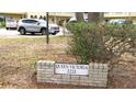 A brick-framed 'Queen Victoria 2221' sign sits beside greenery and groundcover at 2221 Norwegian Dr # 43, Clearwater, FL 33763