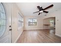 Inviting living area with wood-look flooring, ceiling fan, and natural light from large windows at 2585 9Th N Ave, St Petersburg, FL 33713