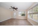 Bright living room with modern ceiling fan, beautiful wood-look flooring, and plenty of natural light at 2585 9Th N Ave, St Petersburg, FL 33713