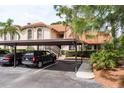 Inviting condo exterior with covered parking, lush landscaping, and classic architectural details, creating a welcoming atmosphere at 2636 Enterprise E Rd # C24, Clearwater, FL 33759