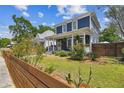 Charming two-story home with a covered front porch and fenced yard, offering curb appeal at 2807 N Morgan St, Tampa, FL 33602