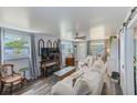 Comfortable living room featuring wood-look floors, neutral paint, and a ceiling fan at 3435 40Th N St, St Petersburg, FL 33713