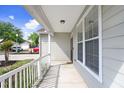 Covered front porch with white railing, offering a welcoming outdoor space at 37438 Picketts Mill Ave, Zephyrhills, FL 33542