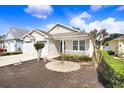 Landscaped front yard featuring a decorative fountain, lush plantings, and a manicured lawn at 37438 Picketts Mill Ave, Zephyrhills, FL 33542