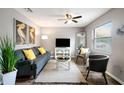 Stylish living room with grey sofa, modern furnishings, and an abundance of natural light at 4127 13Th S Ave, St Petersburg, FL 33711