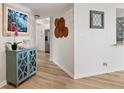 Bright hallway with wood floors leading to kitchen, enhanced by a decorative console table at 5279 Isla Key S Blvd # 212, St Petersburg, FL 33715
