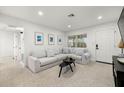 Bright living room featuring a comfortable sectional sofa and a stylish coffee table at 5809 Dartmouth N Ave, St Petersburg, FL 33710