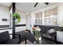 Inviting front porch with neutral furniture and decorative plants at 5809 Dartmouth N Ave, St Petersburg, FL 33710