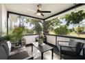 Relaxing screened porch featuring comfortable seating and ceiling fan at 5809 Dartmouth N Ave, St Petersburg, FL 33710