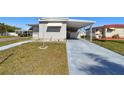 Well-kept home featuring a covered parking area and neatly manicured lawn at 13225 101St St # 107, Largo, FL 33773