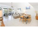 Bright living room featuring balcony access, tile flooring, and comfortable seating with stylish decor at 15 Glendale St # B6, Clearwater Beach, FL 33767