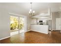 Open dining room with a sliding glass door to the yard and adjacent modern kitchen at 15838 49Th N St, Clearwater, FL 33762