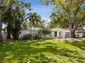 Charming single-story home featuring a brick exterior, mature trees and a well-manicured lawn at 1666 N Dakota Ne Ave, St Petersburg, FL 33703