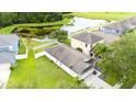 Aerial view of backyard featuring lush greenery and scenic pond views at 18150 Leamington Ln, Land O Lakes, FL 34638
