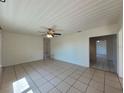 Bright living room with tile flooring, ceiling fan, and a seamless flow into other rooms at 204 Shore W Dr, Oldsmar, FL 34677