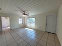 Inviting living room with tile flooring, ceiling fan, and natural light streaming through the windows at 204 Shore W Dr, Oldsmar, FL 34677