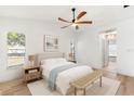 Bright bedroom with ceiling fan, a neutral color scheme, and direct access to the hallway at 2449 Running Oak Ct, Spring Hill, FL 34608