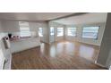 A light-filled living room features modern flooring and flows into the kitchen at 4851 W Gandy Blvd # B2L11, Tampa, FL 33611