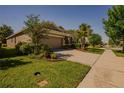 Landscaped front yard and two-car garage of this single-story home on a corner lot at 6312 Lantern View Pl, Apollo Beach, FL 33572