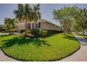 Well-maintained lawn and landscaping surround this home's exterior, complemented by a sidewalk on a sunny day at 6312 Lantern View Pl, Apollo Beach, FL 33572