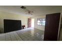 The living room features tile flooring and a ceiling fan at 704 Lemonwood Dr, Oldsmar, FL 34677
