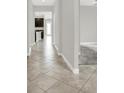 Inviting hallway with light gray walls, tile floors, and views into the open-concept living spaces at 7336 Bagley Cove Ct, Sun City Center, FL 33573