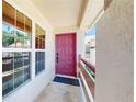 Charming raspberry front door with a window and a view of the exterior at 7802 Hardwick Dr # 1126, New Port Richey, FL 34653
