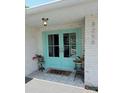 Inviting front entrance with stylish double doors and decorative potted plants at 8258 Forest Cir, Seminole, FL 33776