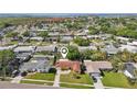 Aerial view of a residential neighborhood showcasing a well-located home with a landscaped yard near waterfront at 8408 Flagstone Dr, Tampa, FL 33615
