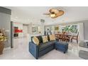 Bright open-concept living room with new marble floors, a comfortable couch, and a view of the dining area at 8408 Flagstone Dr, Tampa, FL 33615