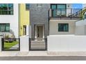 Contemporary townhome featuring a gated entrance, striking brickwork, and a minimalist design at 907 Arlington N Ave, St Petersburg, FL 33705